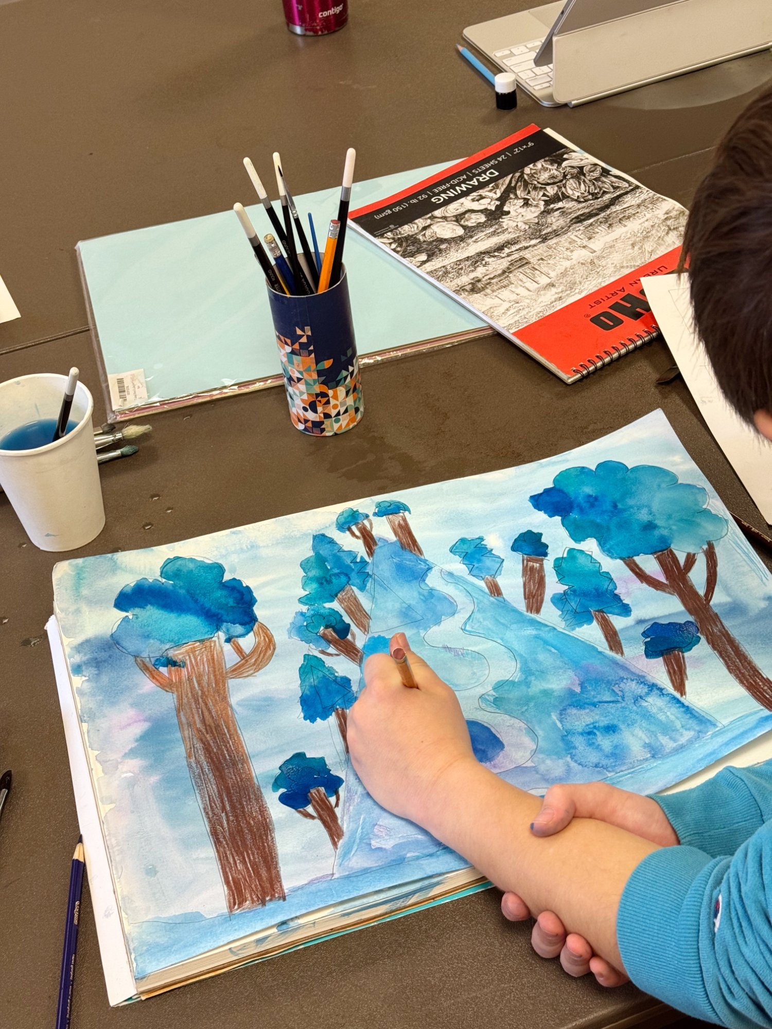 Kid painting watercolor landscape