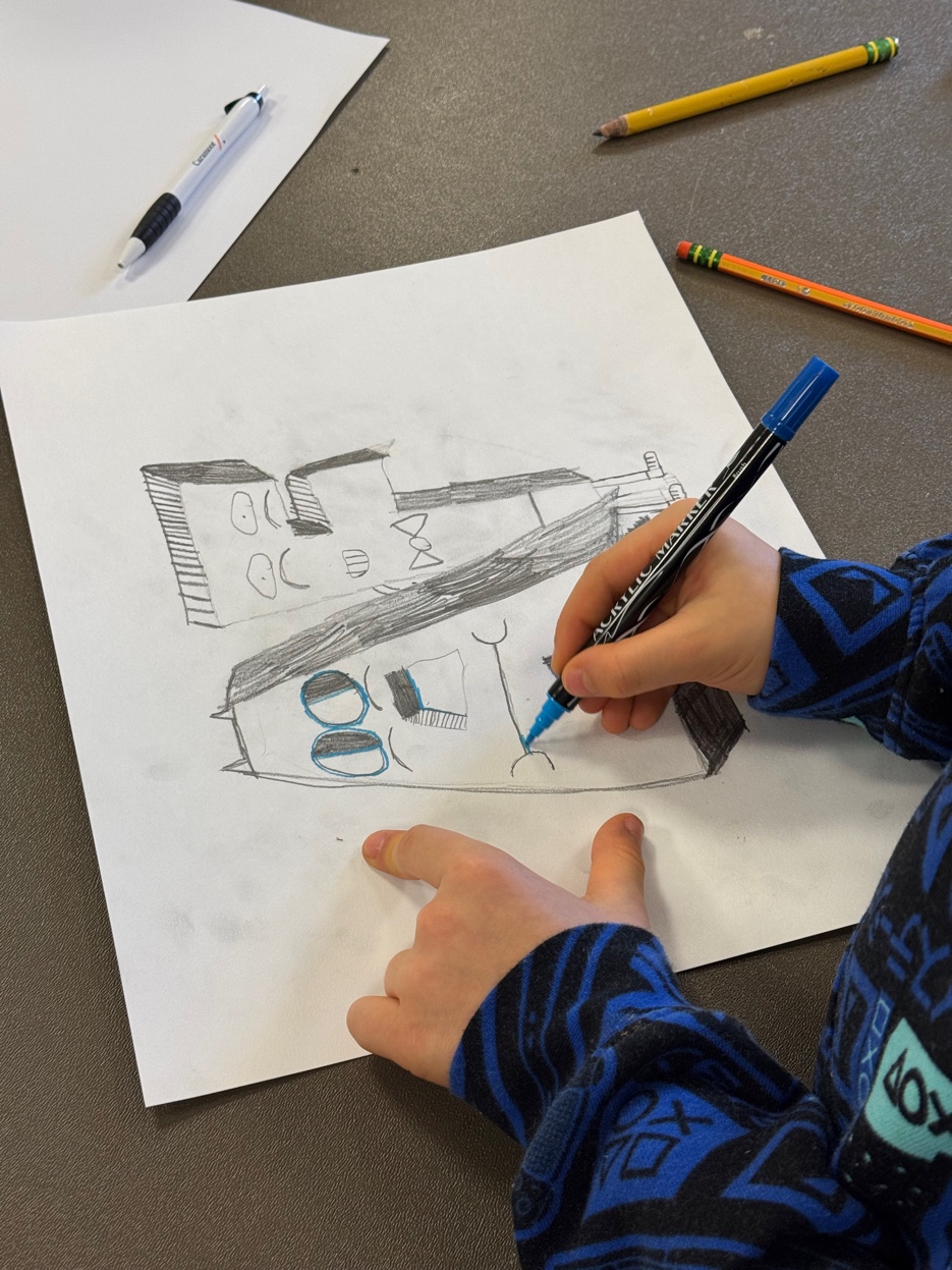 Kid sketching initials project in progress